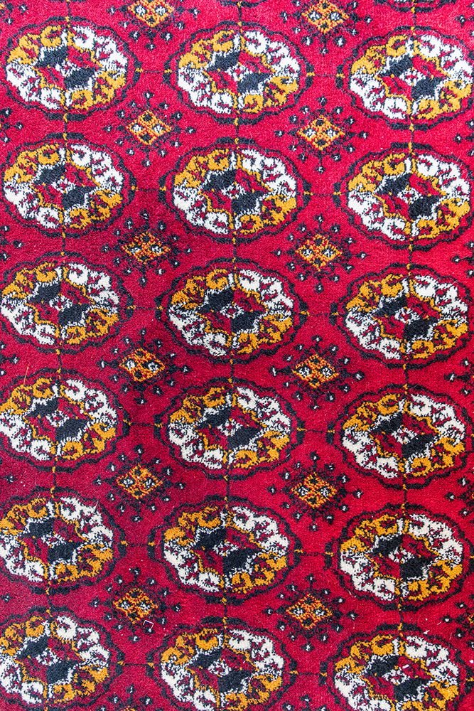 Khiva, Xorazm Region, Uzbekistan, Central Asia. Traditional red rug at the Khan palace.